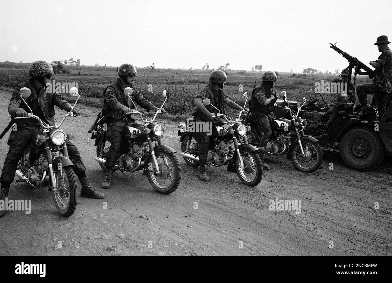 Four bike riders of a recon patrol check with platoon leader lt steve