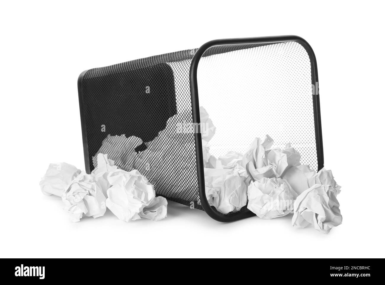 Basket with scattered crumpled paper balls on white background Stock Photo