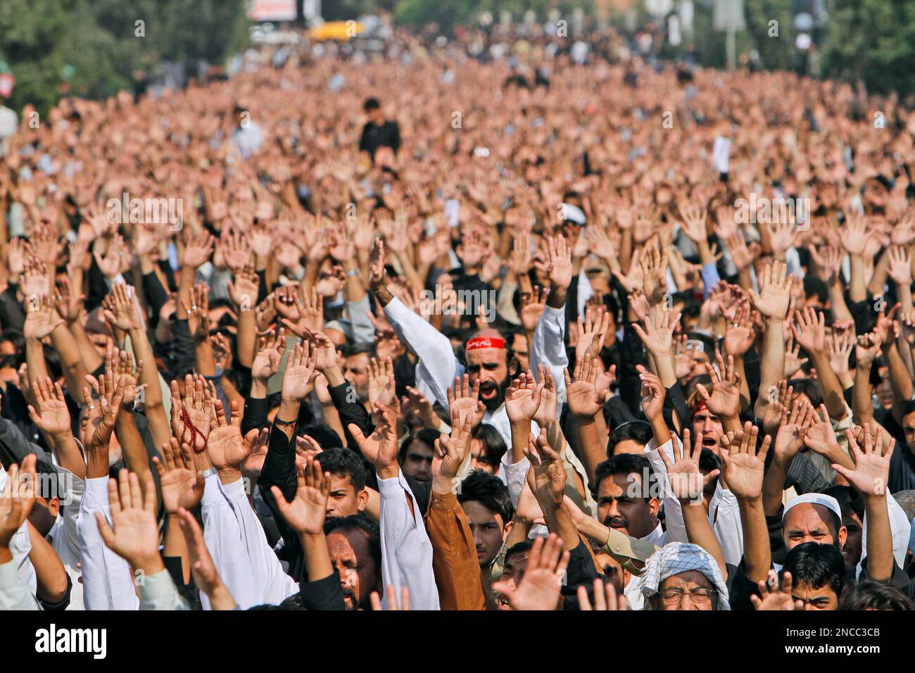 Pakistani Shiite Muslims raise their hands as they chant anti-US and ...