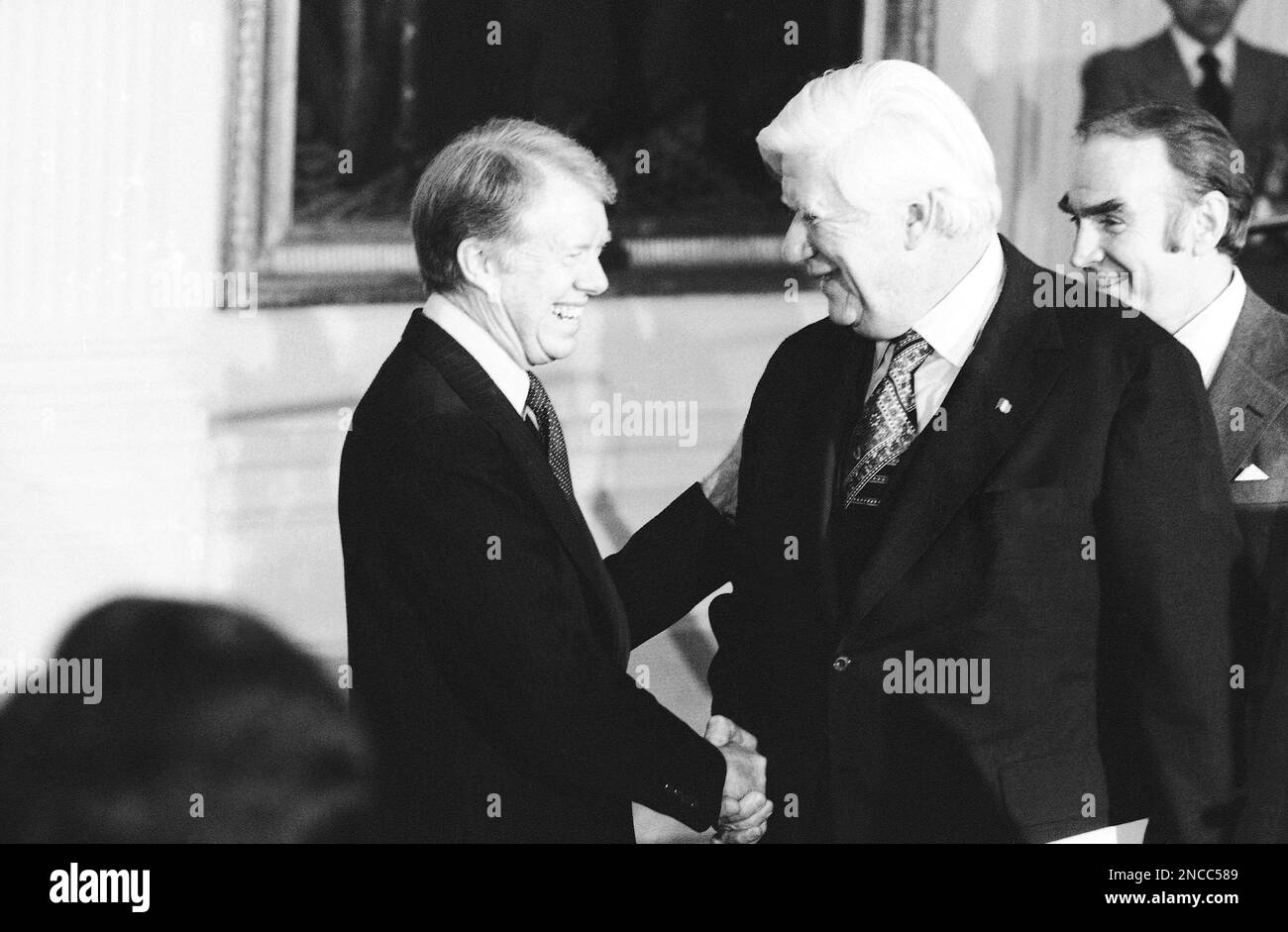 President Jimmy Carter shaking hands with Tip O'Neill, Speaker of the