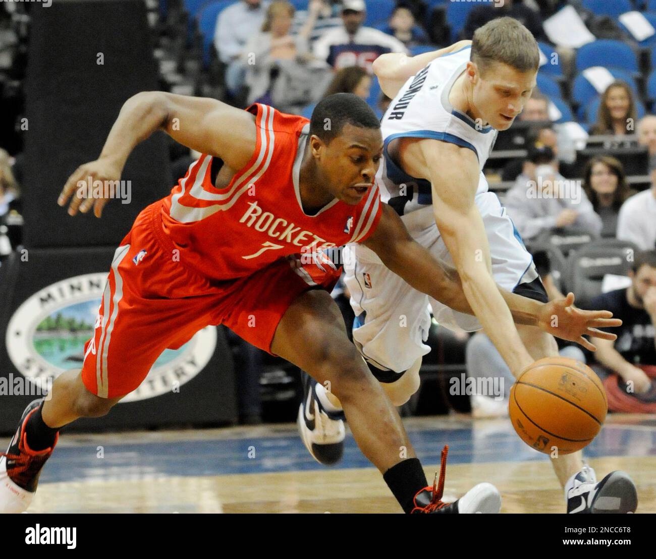 Minnesota Timberwolves' Luke Ridnour, right, and Houston Rockets' Kyle