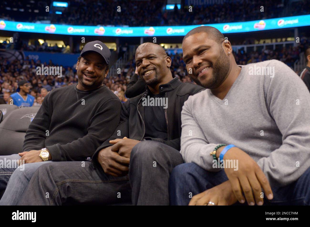 Actors Alfonso Ribeiro left Terry Crews center and Anthony Anderson pose for a photograph during the first half of an NBA basketball game between the Orlando Magic and Toronto Raptors in Orlando