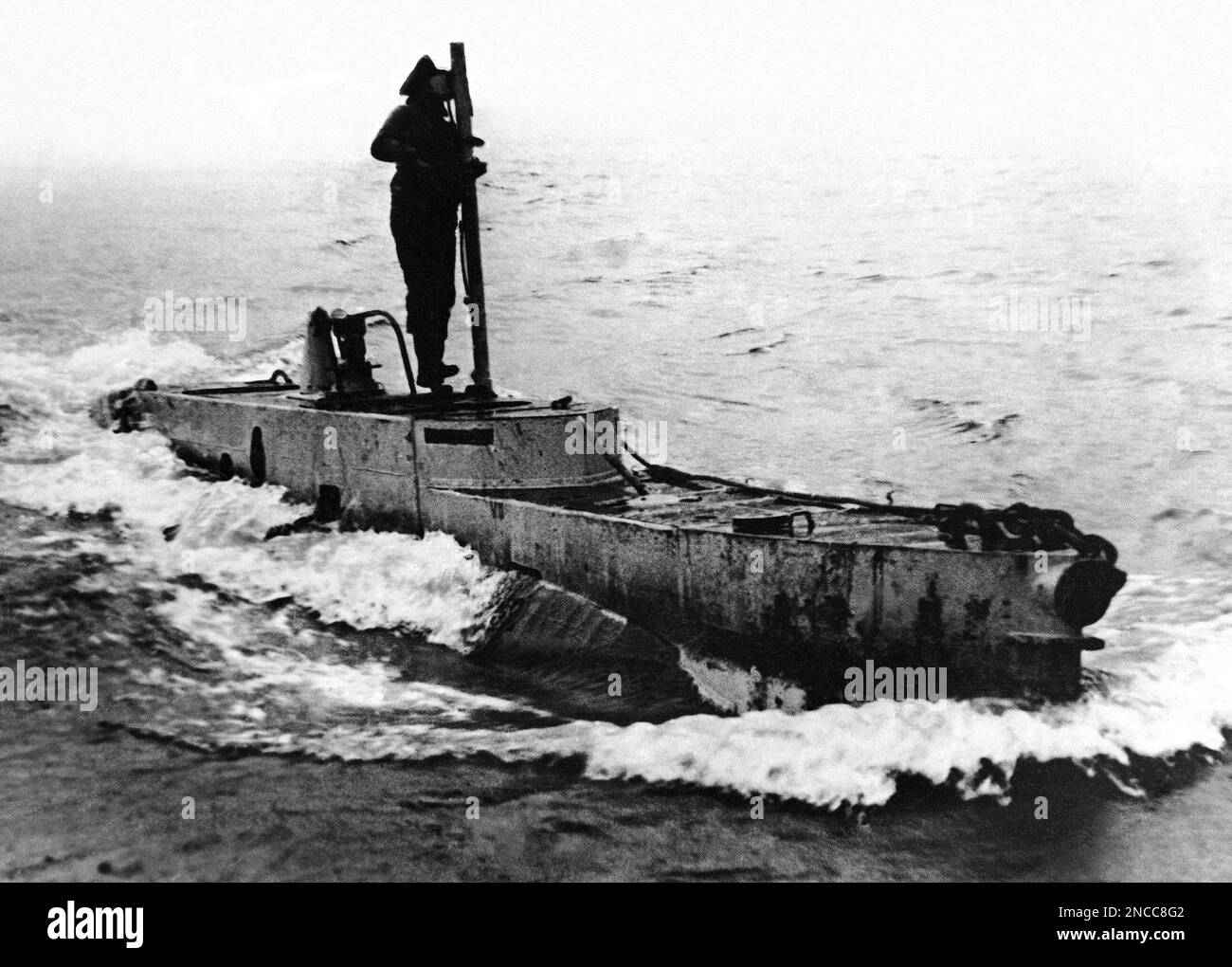 Britain’s Xcraft, or Midget submarine Xcraft, under way showing a member of her crew on the