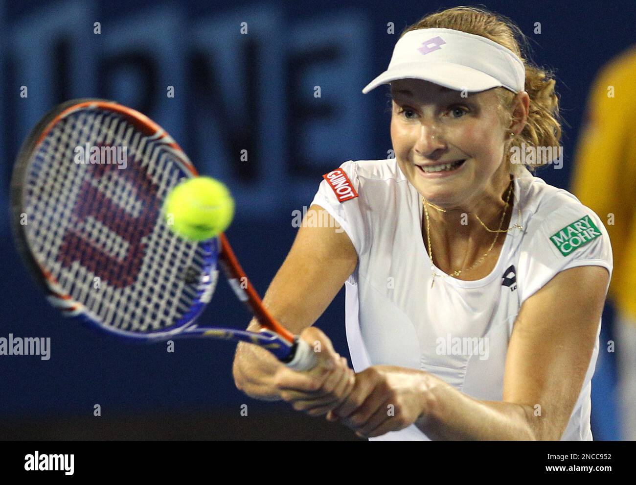 Ekaterina Makarova of Russia hits a backhand return to Kim Clijsters of