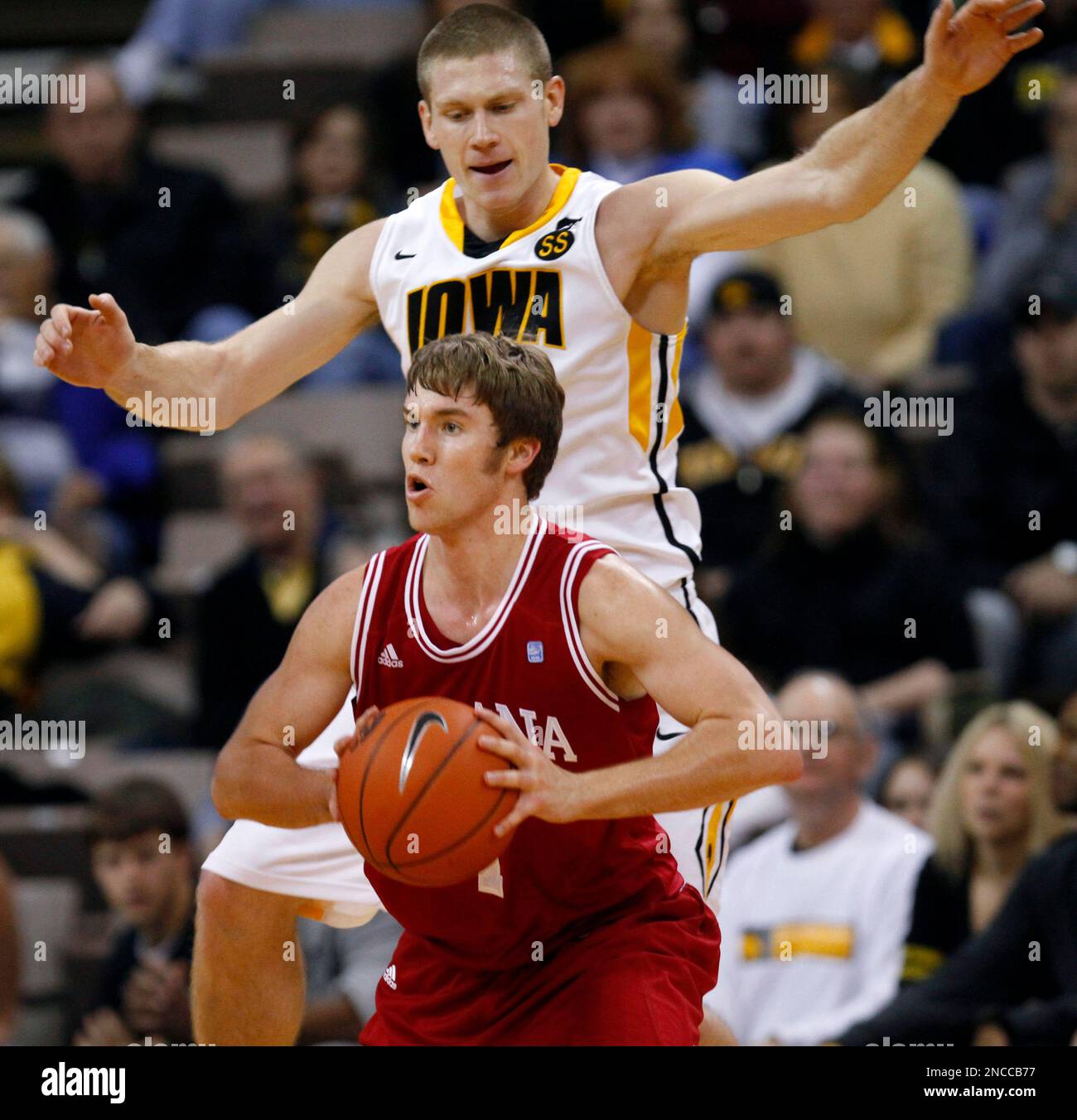 Indiana guard Jordan Hulls looks to pass in front of Iowa guard Matt