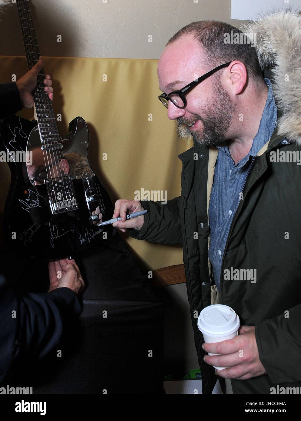 Actor Paul Giamatti signs a Fender guitar at the Fender Music Lodge during  the 2011 Sundance Film Festival on Saturday, Jan. 22, 2011 in Park City UT.  (AP Images for Fender Music