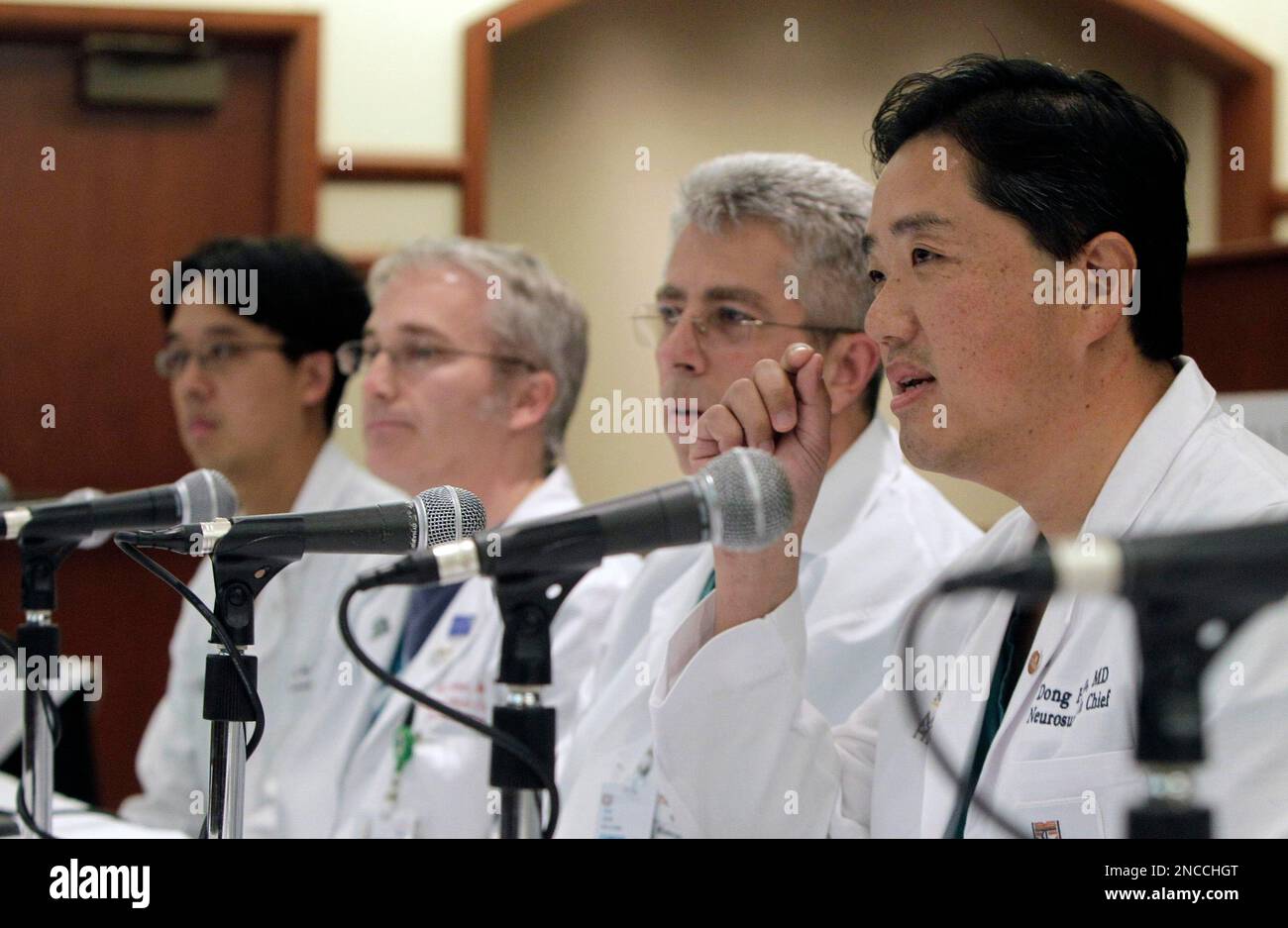 Neurosurgeon Dong Kim, right, speaks at a press conference regarding