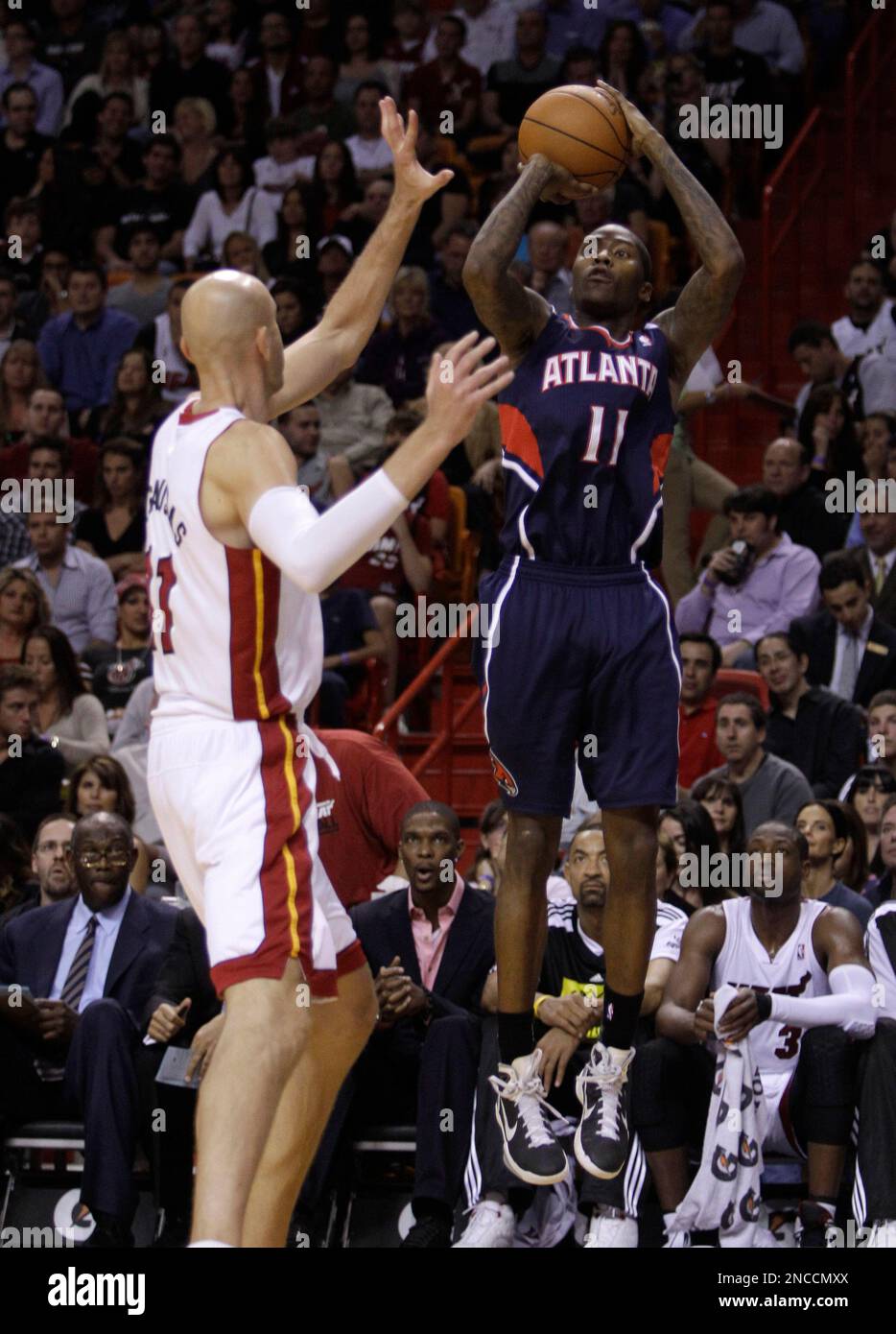 Atlanta Hawks' Jamal Crawford (11) shoots as Miami Heat's Zydrunas