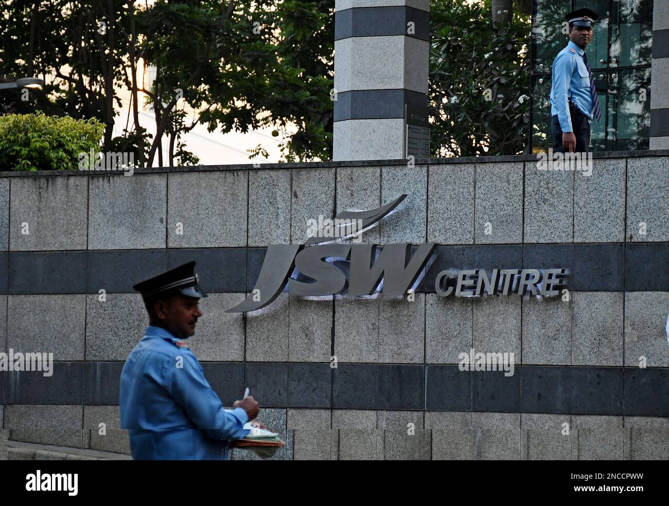 Mumbai, Maharashtra, India. 14th Feb, 2023. Security guards seen near the Jindal South West (JSW) logo below their office building in Mumbai. Jindal South West (JSW) is an Indian multinational company with a diversified business into steel, energy, infrastructure, cement, paints, venture capital and sports. The company's office is spread across India, USA, Europe and Africa. (Credit Image: © Ashish Vaishnav/SOPA Images via ZUMA Press Wire) EDITORIAL USAGE ONLY! Not for Commercial USAGE! Stock Photo