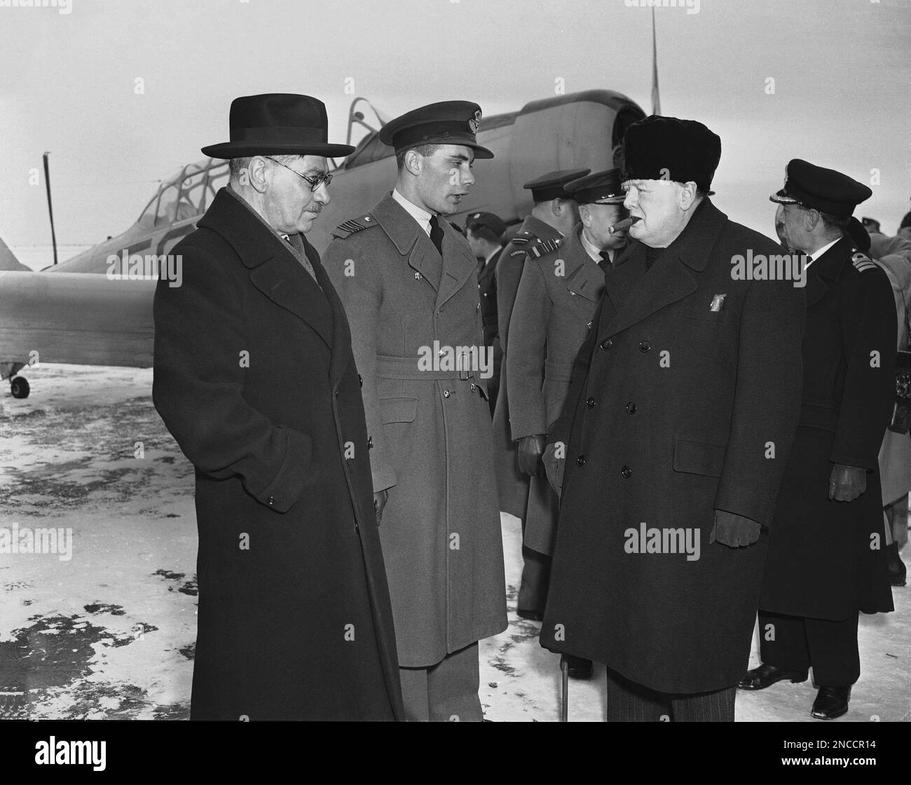 Prime Minister Winston Churchill, right, wearing his new fur cap talks