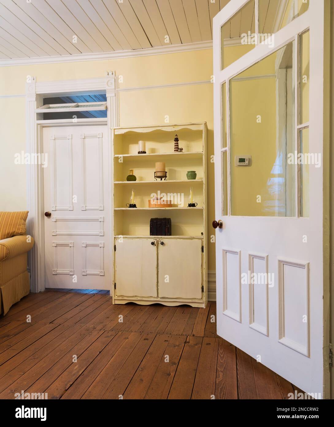 Antique pinewood bookcase next to master bedroom door in upstairs