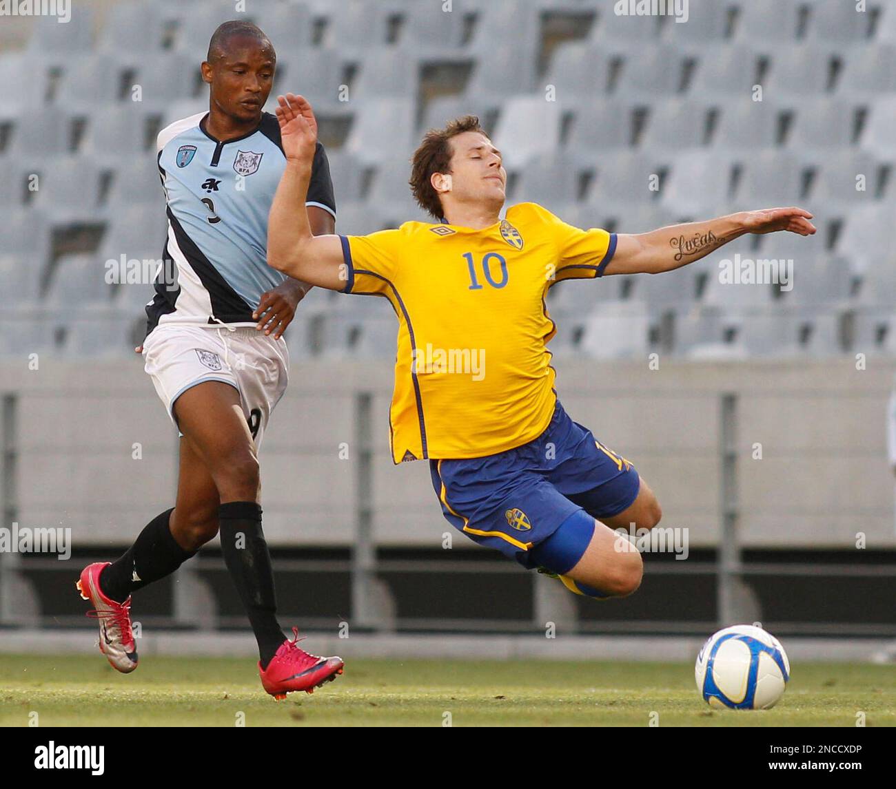 Botswana's Jerome Ramathakwane, left, fights for the ball against 