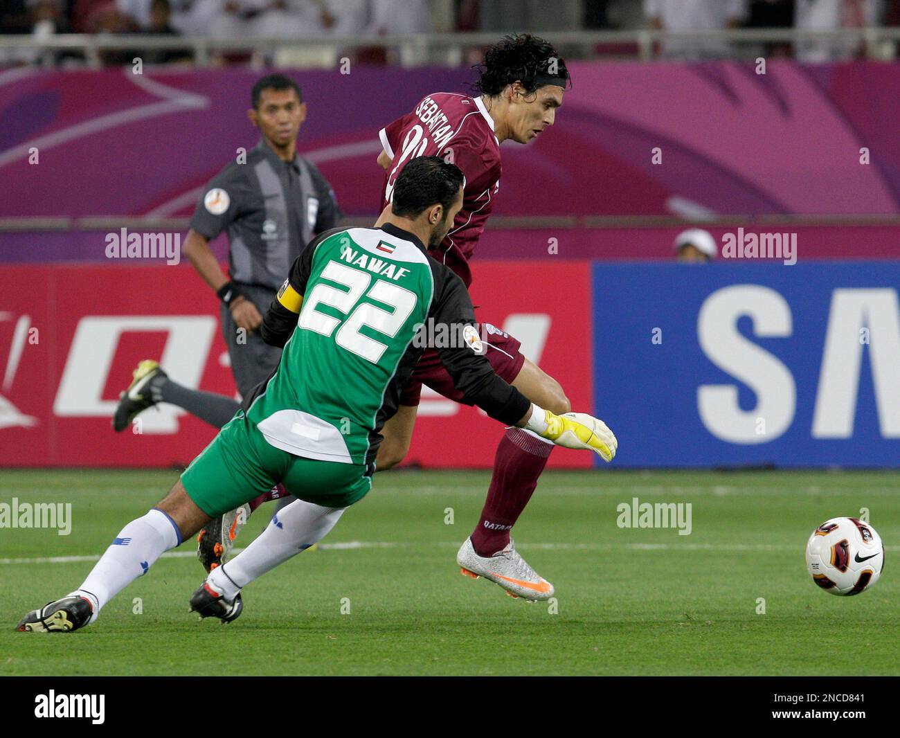 Kuwait's goalkeeper Nawaf Al Khaldi, foreground, tries to save the ball