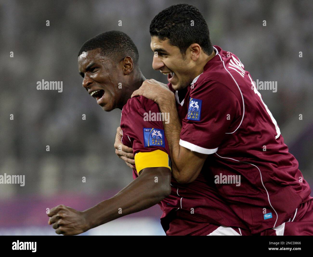 Qatar's Bilal Mohammed, left, celebrates scoring against Kuwait with