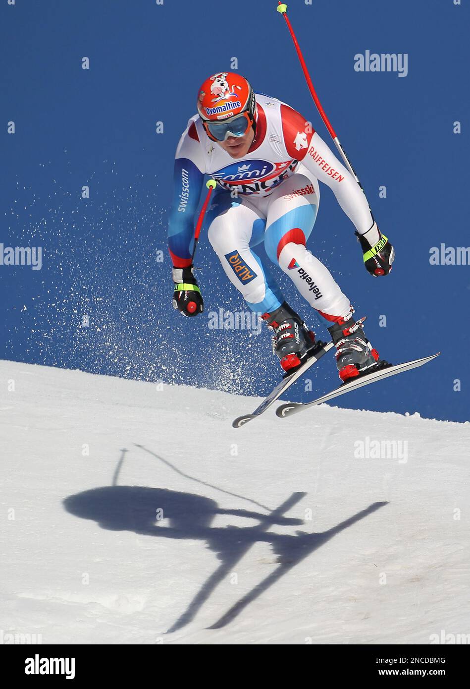 Switzerland's Didier Cuche is airborne as he speeds on his way to take