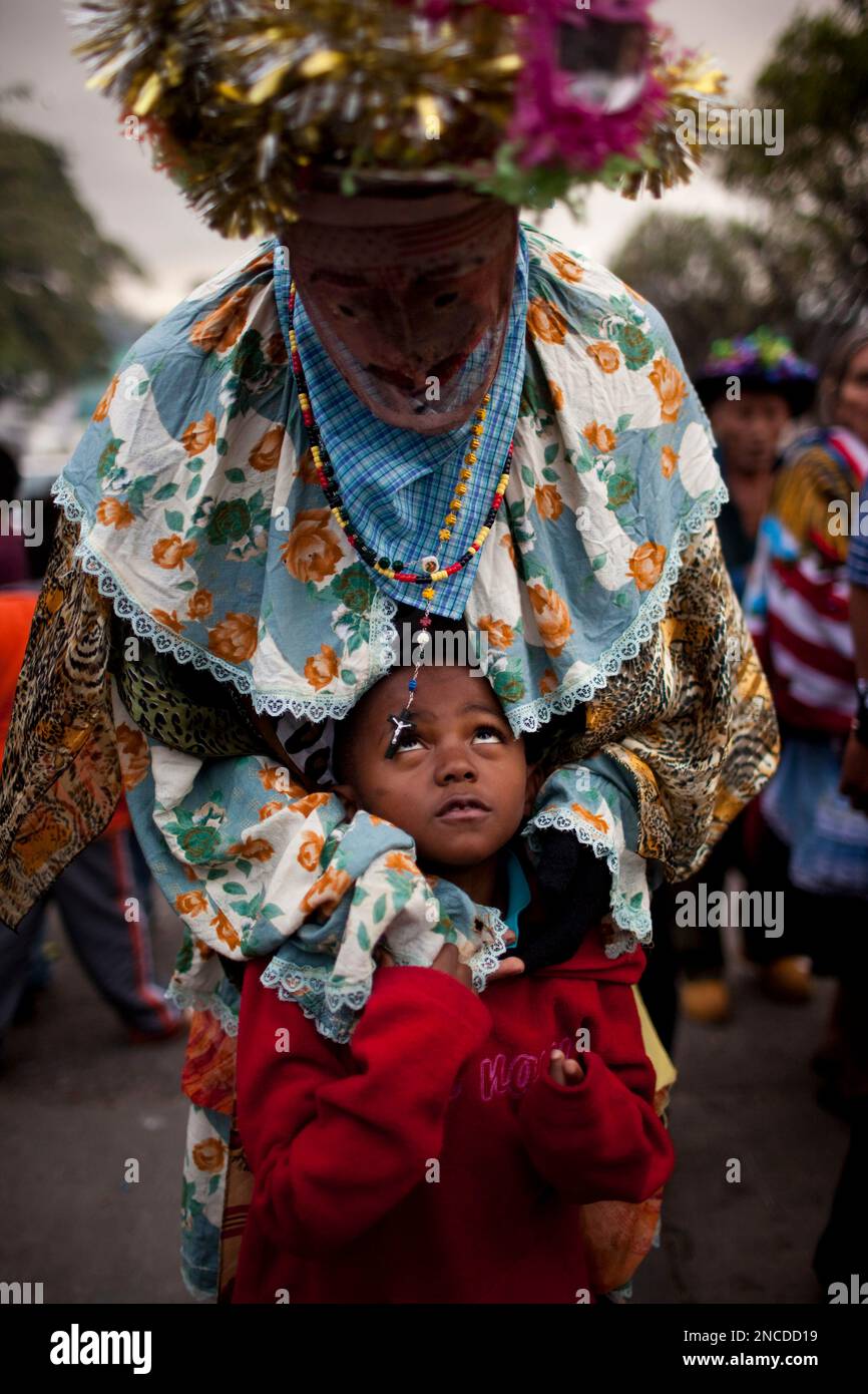 Titi Alvarez looks up at a Garifuna de Livingston performer taking a ...