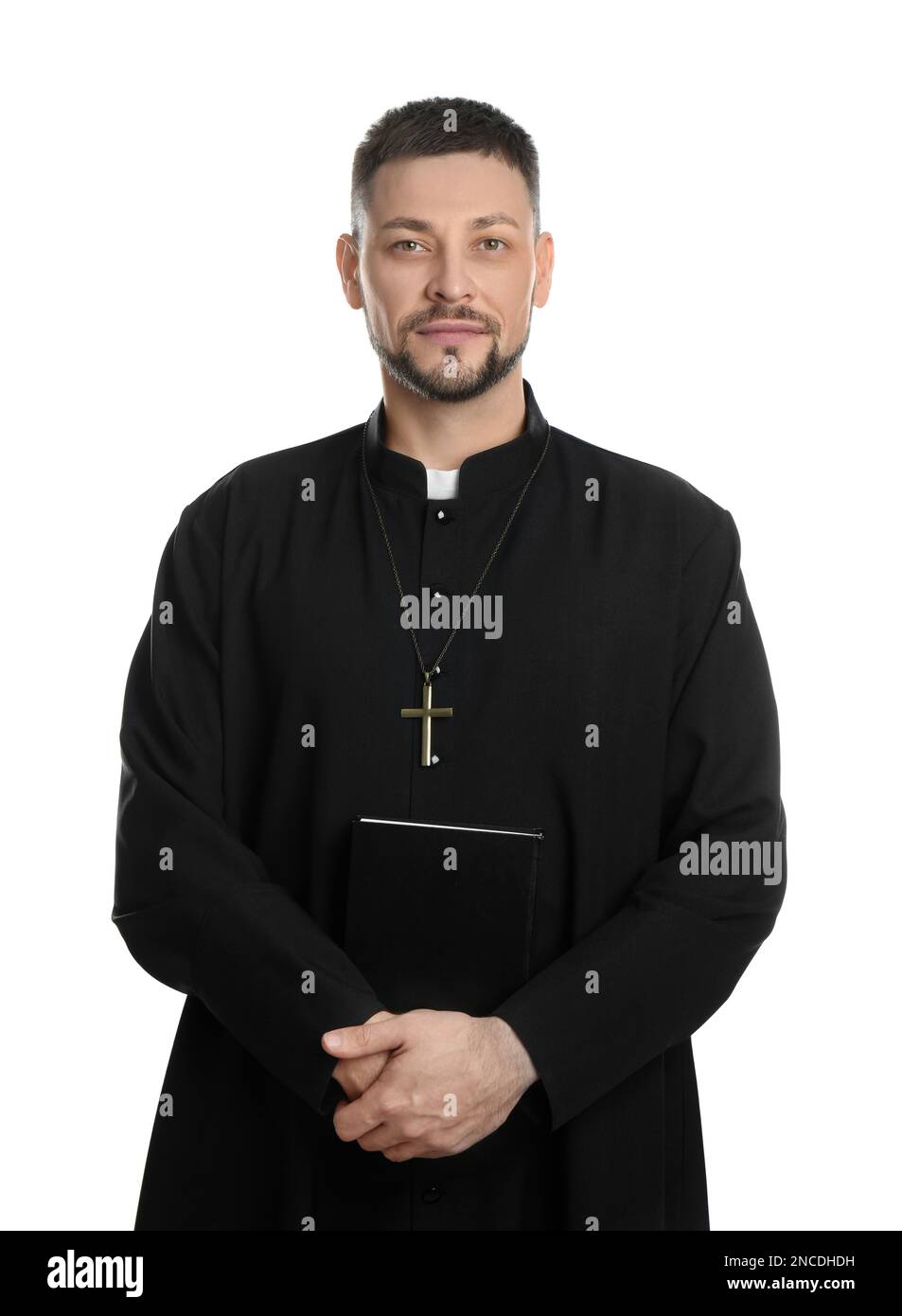 Priest with Bible and cross on white background Stock Photo