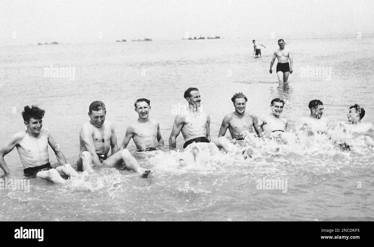British soldiers have the time of their lives as they sit in the surf ...