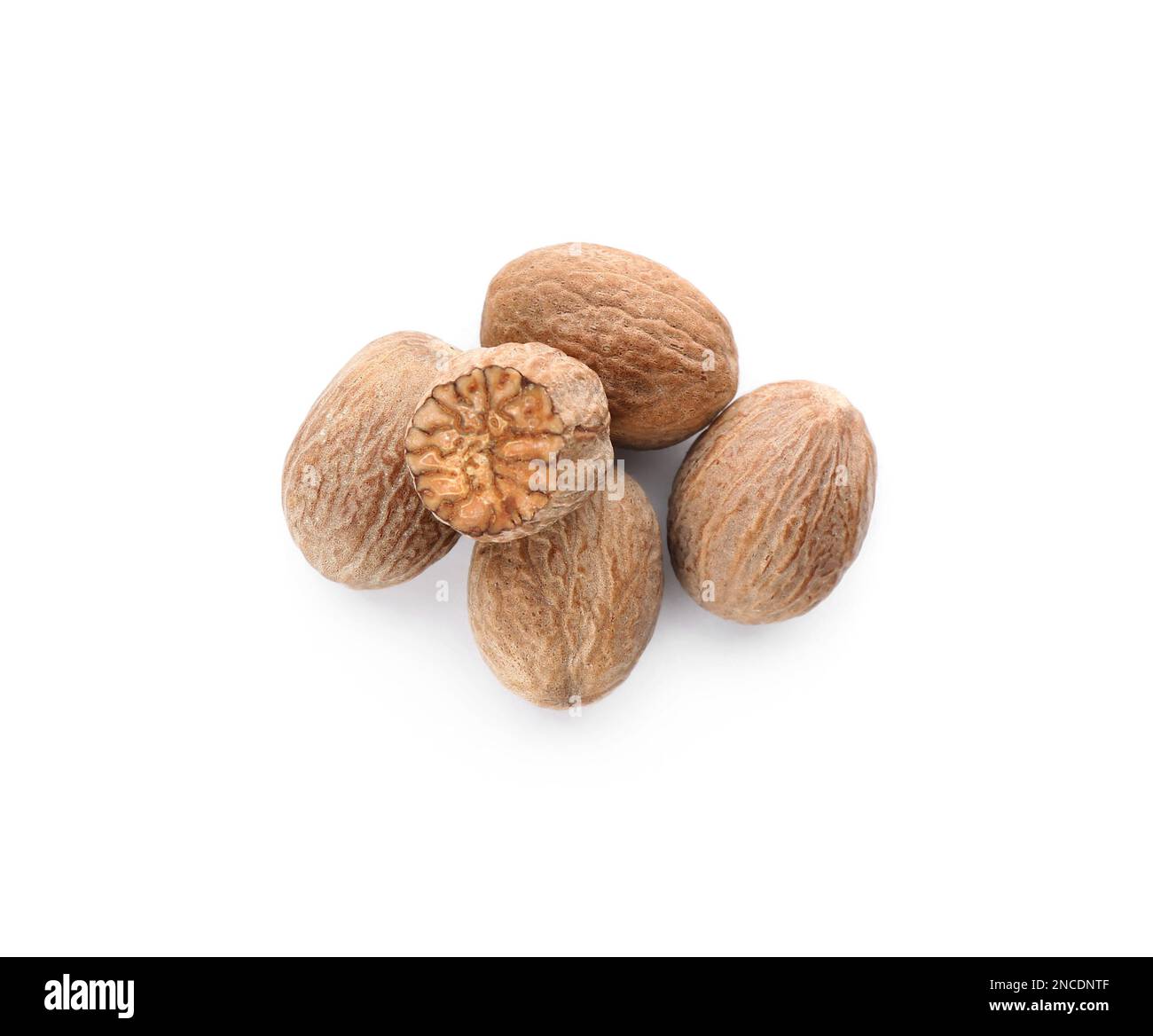 Whole and cut nutmeg seeds isolated on white, top view Stock Photo - Alamy