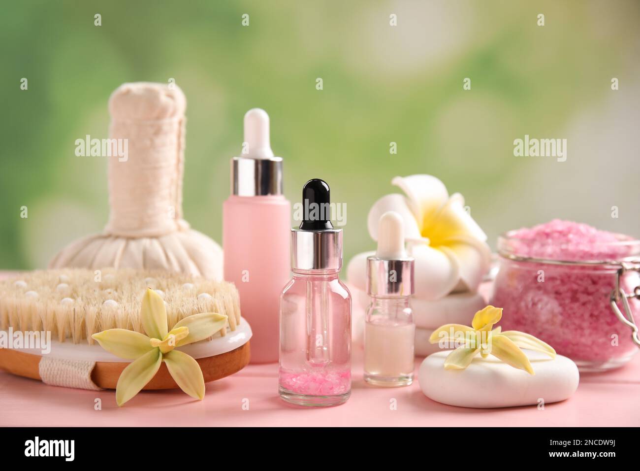 https://c8.alamy.com/comp/2NCDW9J/composition-with-spa-cosmetic-and-flowers-on-pink-wooden-table-2NCDW9J.jpg