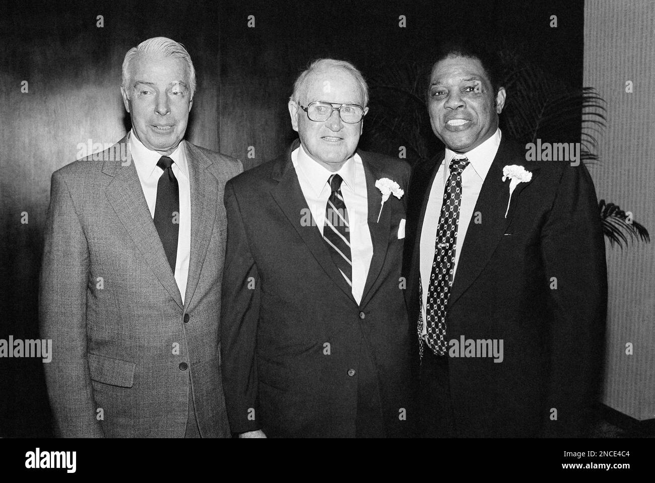 Hall of Fame baseball stars Joe DiMaggio, left, and Willie Mays, right