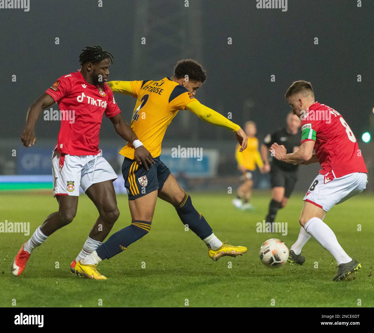 Wrexham, Wales. 14th February 2023. Wrexham captain Luke Young & Jacob Mendy battle for the ball from Woking's Kyran Lofthouse, during Wrexham Association Football Club V Woking Football Club at The Racecourse Ground, in in the Vanarama National League. (Credit Image: ©Cody Froggatt/Alamy Live News) Stock Photo