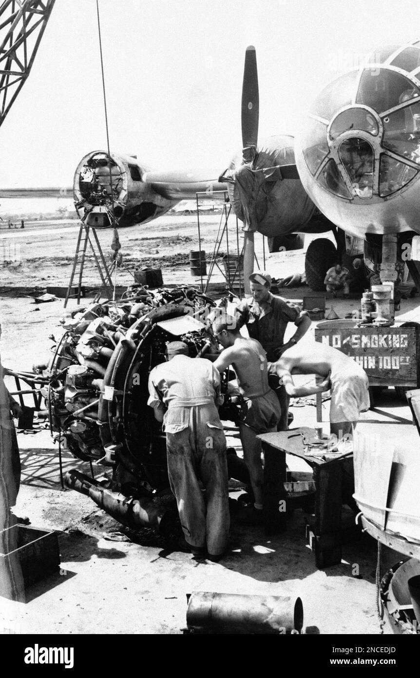 Ground crew members work on one of the mighty engines to be installed in a B29 Superfortress