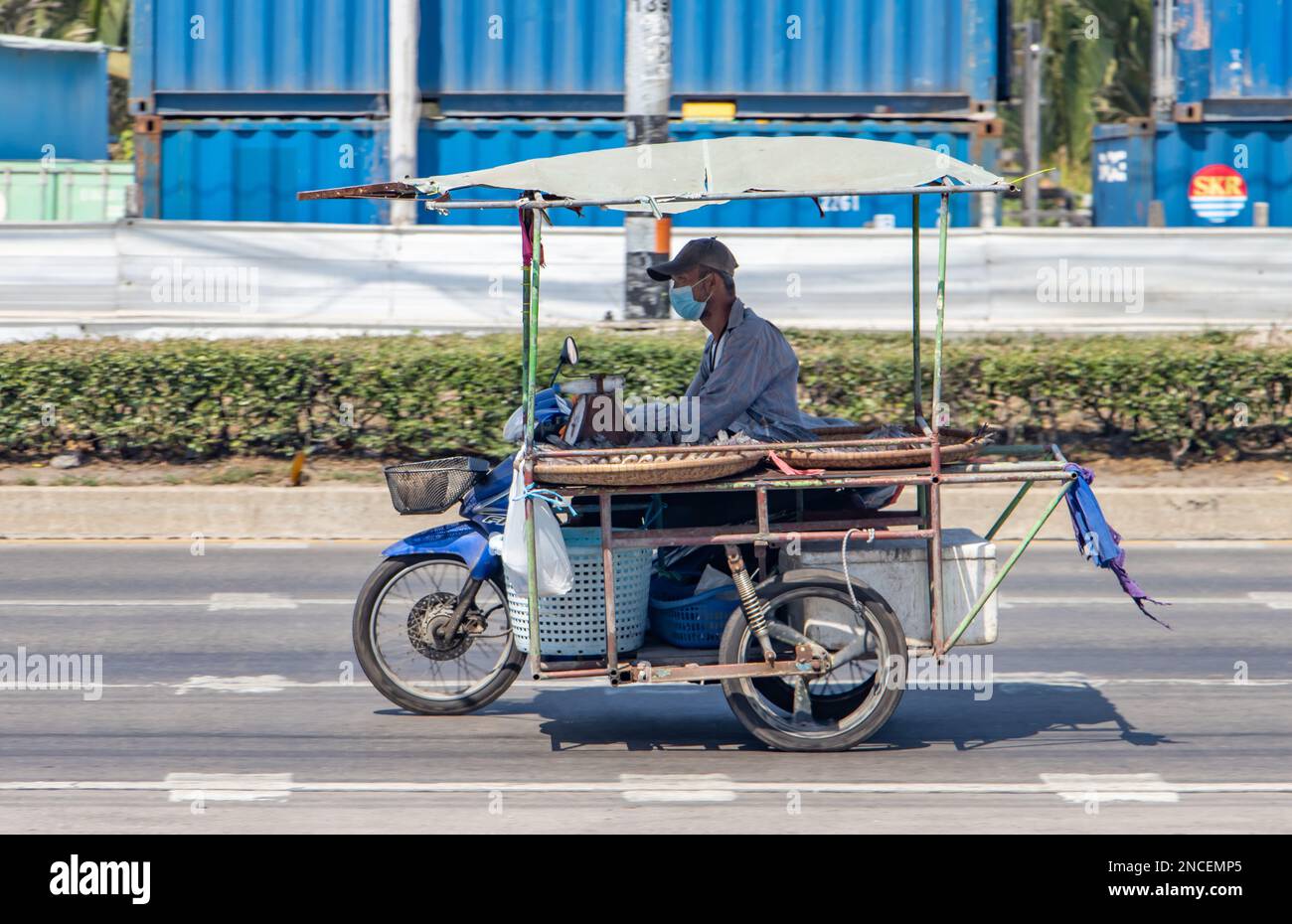 SAMUT PRAKAN, THAILAND, JAN 29 2023, The vendor with fish rides a three ...