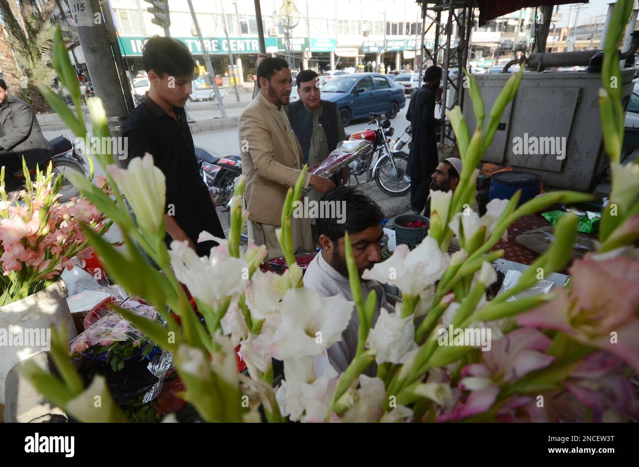 Peshawar, Pakistan. 14th Feb, 2023. People buy flowers at a flower shop
