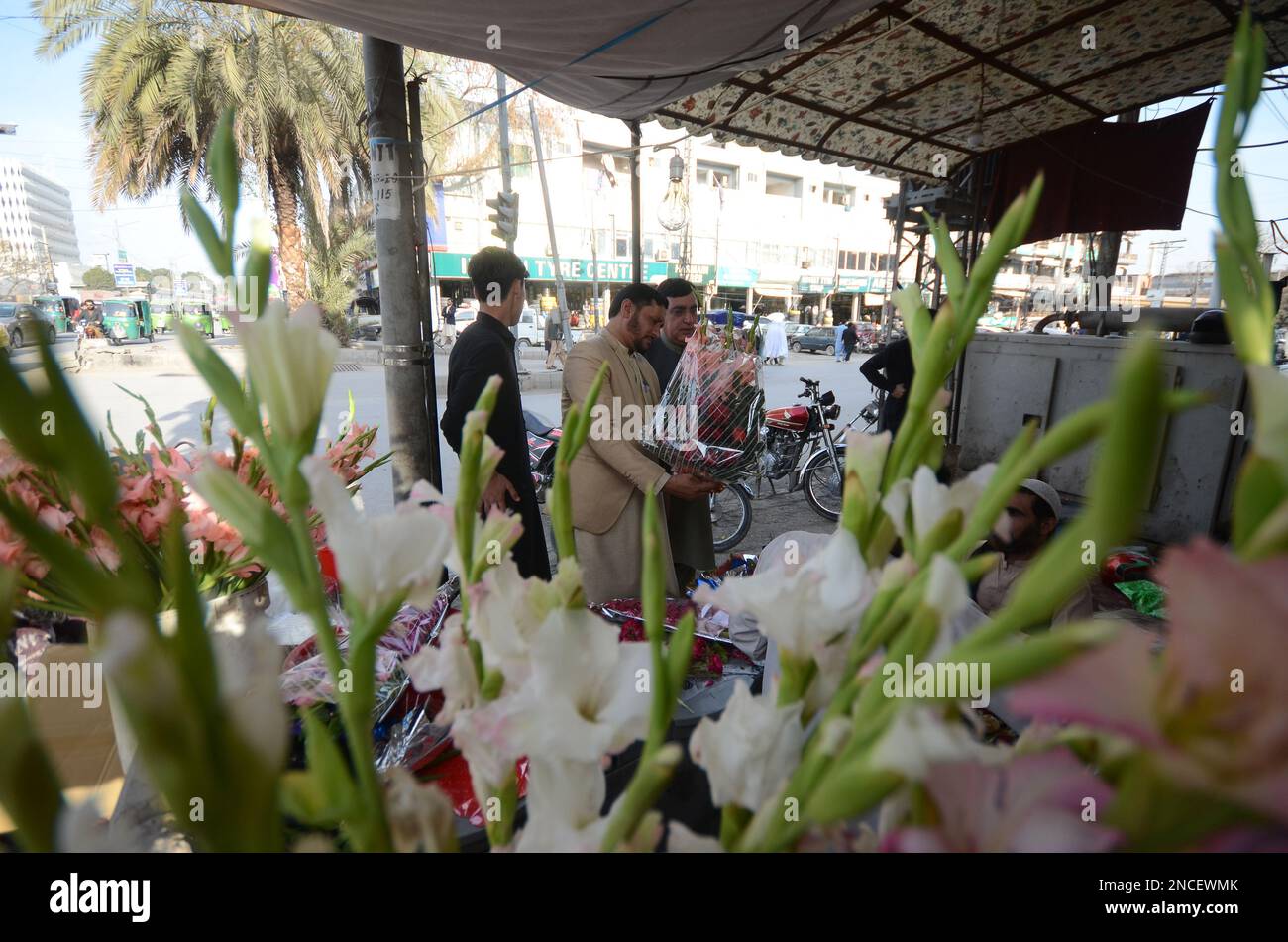 Peshawar, Pakistan. 14th Feb, 2023. People buy flowers at a flower shop