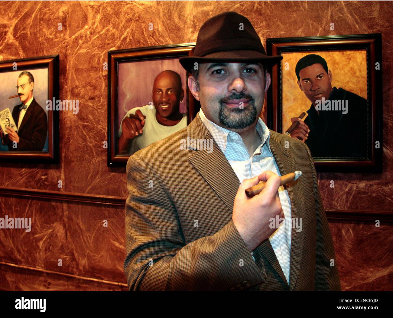 owner of tobacco company Ismail Houmani, founder and director of La Casa De La Habana, enjoys a  cigar at his establishment on Wednesday, Dec. 22, 2010 in Detroit. Cuba's  government-controlled tobacco company is suing the owner