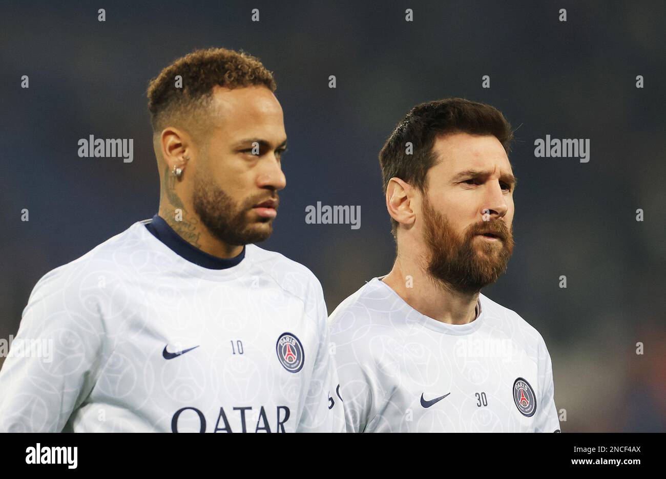 Paris, France. 14th Feb, 2023. Paris Saint-Germain's Neymar (L) and Lionel Messi warm up before the first leg of the UEFA Champions League round of 16 football match between Paris Saint-Germain (PSG) and FC Bayern Munich at the Parc des Princes stadium in Paris on Feb. 14, 2023. Credit: Gao Jing/Xinhua/Alamy Live News Stock Photo