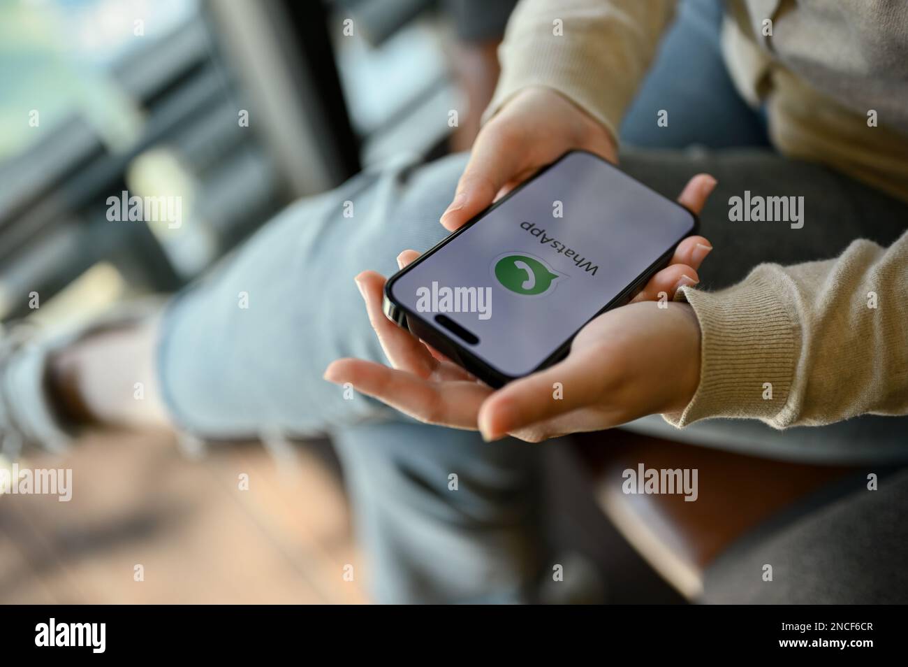 Chiang mai, Thailand - Feb 14 2023: Close-up image of an Asian woman using WhatsApp mobile application to chat with her friends while relaxing in the Stock Photo