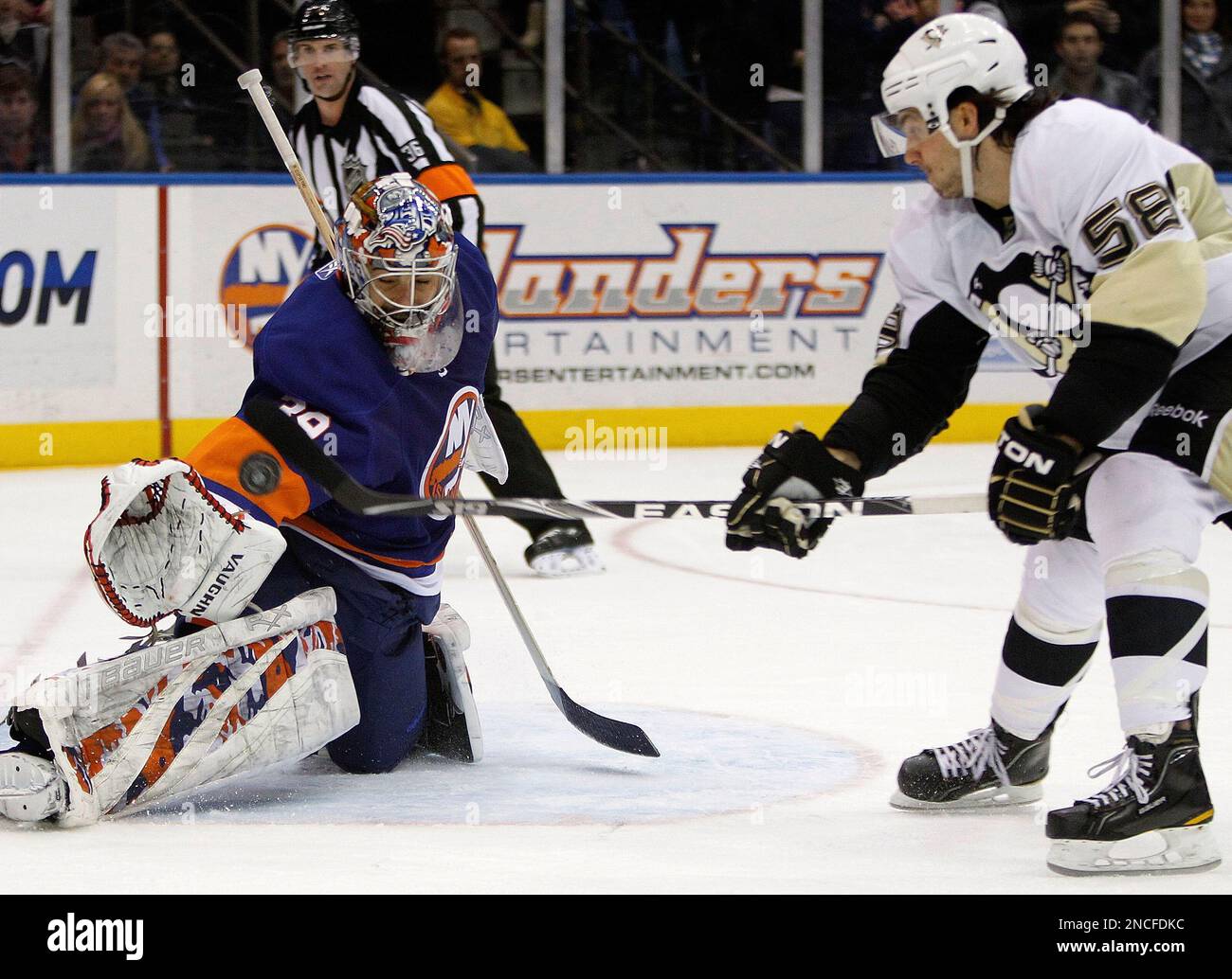 New York Islanders goalie Rick DiPietro (39) makes a penalty shot save by  stopping Pittsburgh Penguins defenseman Kris Letang's shot in the third  period of their NHL hockey game at Nassau Coliseum