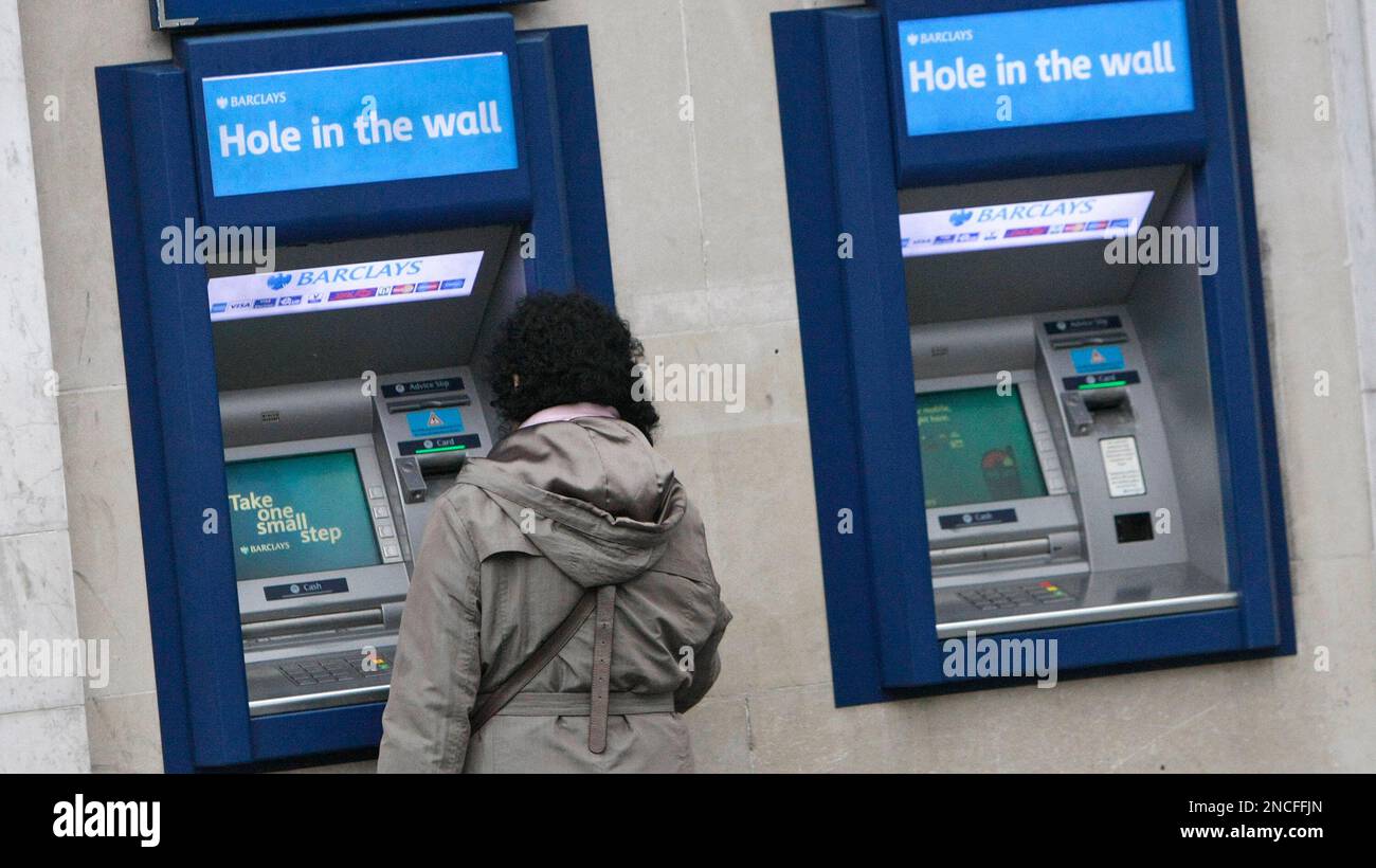 A woman uses an ATM machine in central London, Wednesday, Dec., 29 