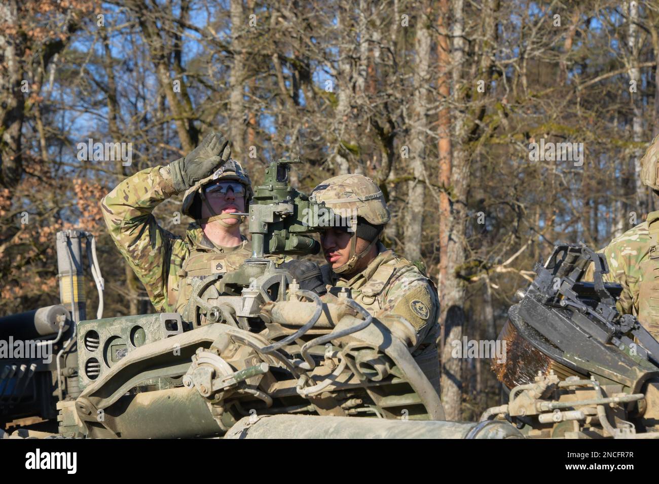 U.S. Soldiers assigned to Field Artillery Squadron, 2nd Cavalry Regiment aligns a M777 155mm howitzer to a targets coordinates during Table XVIII certifications as part of Dragoon Ready 23 exercise at the 7th Army Training Command’s Grafenwoehr Training Area, Germany, February 9, 2023. Dragoon Ready 23 is designed to ensure readiness and train the regiment in its mission-essential tasks in support of unified land operations to enhance proficiency and improve interoperability with NATO Allies. (U.S. Army photo by Spc. Ryan Parr) Stock Photo