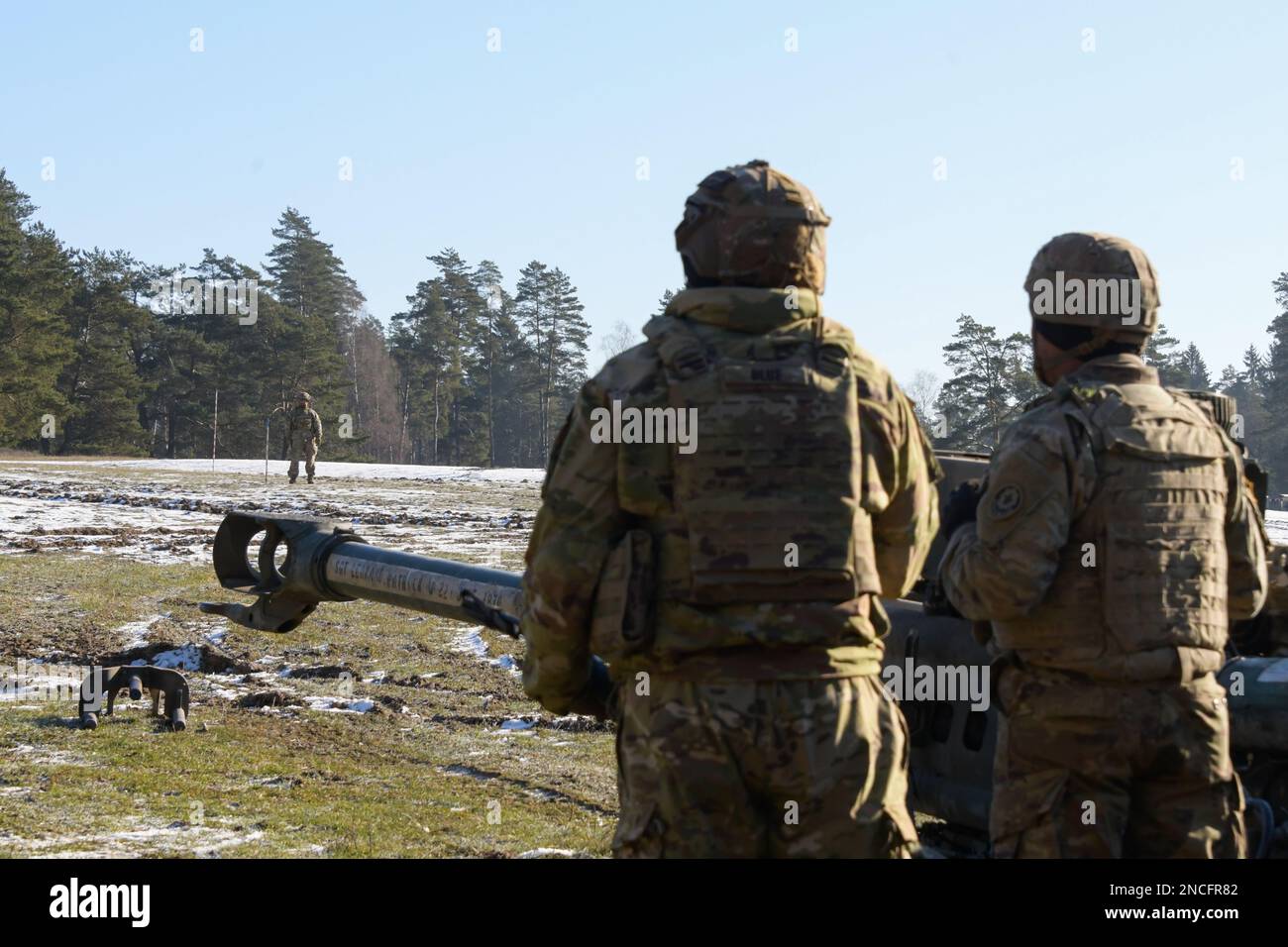 U.S. Soldiers calibrate a aligns a M777 155mm howitzer during Table XVIII certifications as part of Dragoon Ready 23 exercise at the 7th Army Training Command’s Grafenwoehr Training Area, Germany, February 9, 2023. Dragoon Ready 23 is designed to ensure readiness and train the regiment in its mission-essential tasks in support of unified land operations to enhance proficiency and improve interoperability with NATO Allies. (U.S. Army photo by Spc. Ryan Parr) Stock Photo