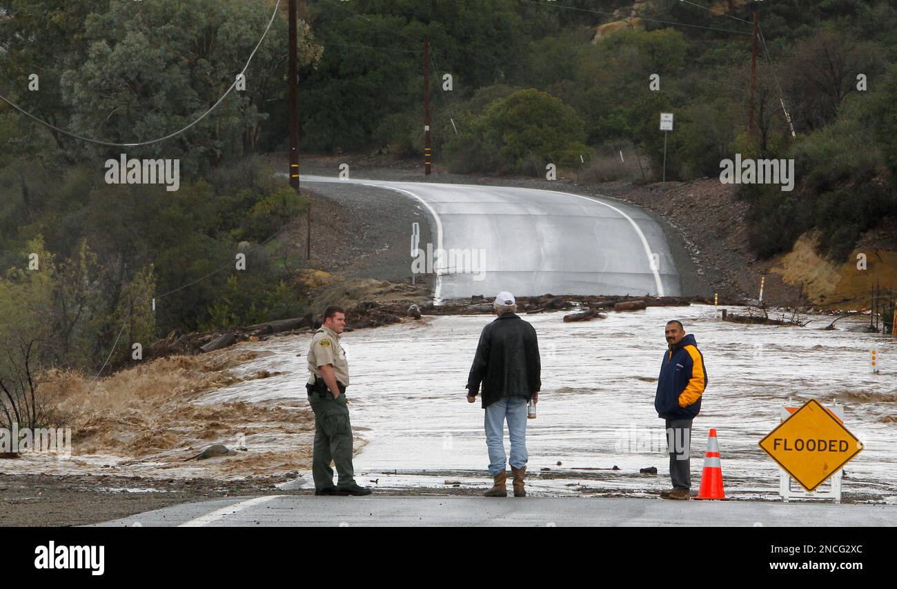 An Orange County Park Ranger and two residents inspect Silverado Creek