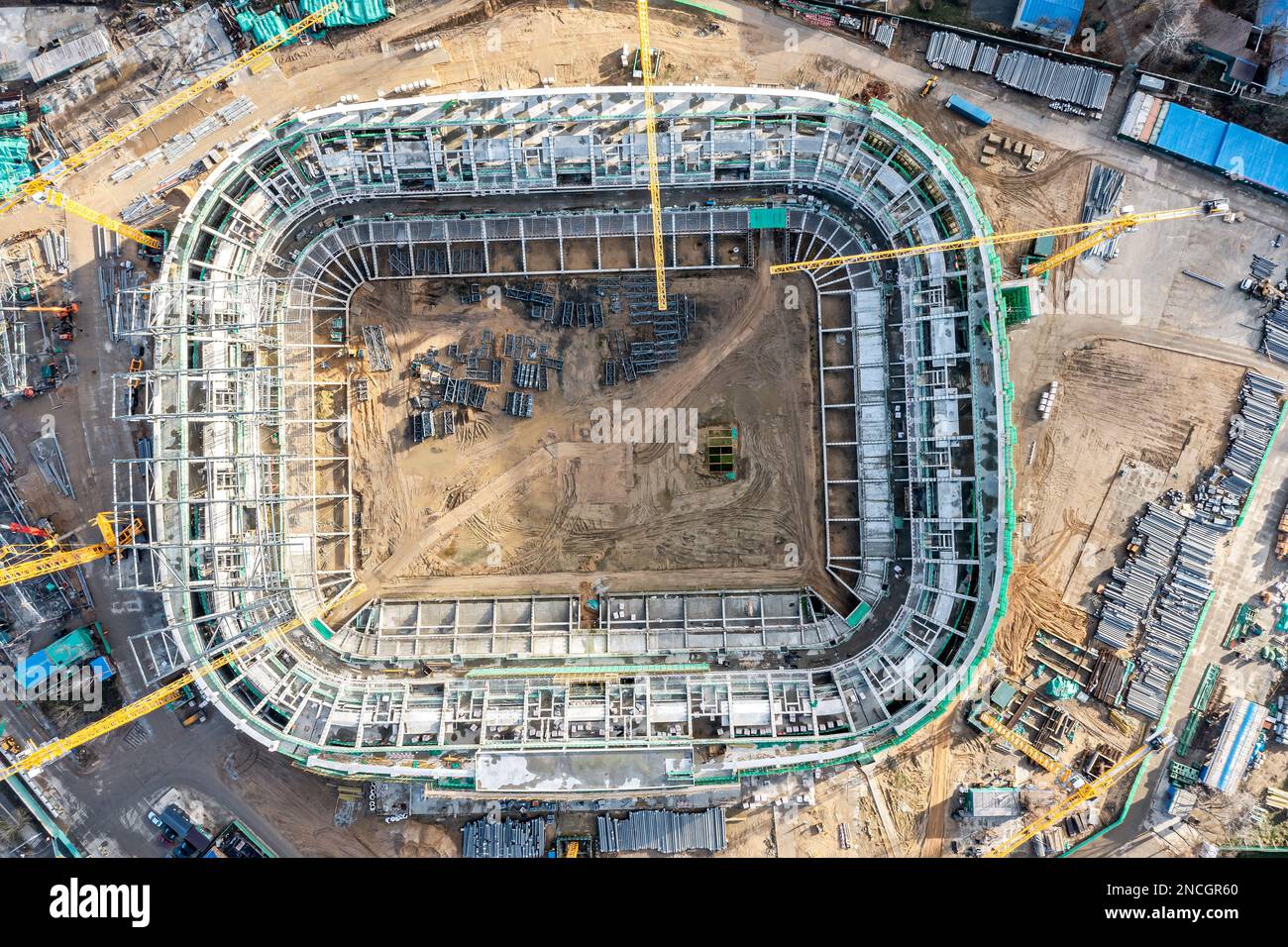 MINSK, BELARUS - 13 NOVEMBER, 2022: Construction of new football stadium. Aerial top view of construction equipment, cranes, heavy machinery and build Stock Photo
