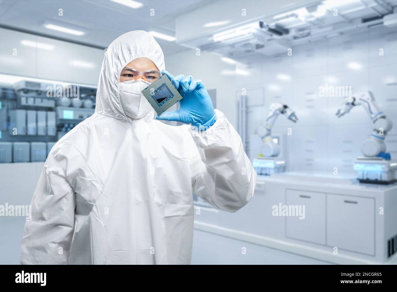 Worker or engineer wears medical protective suit or white coverall suit with chipset Stock Photo
