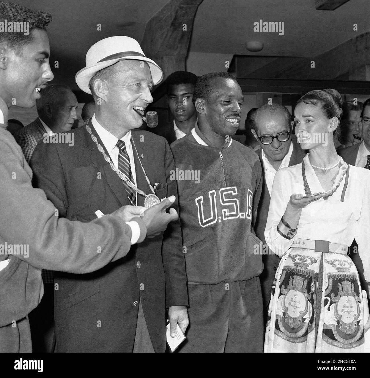 Bing Crosby and his wife, Kathy, try the feel of Olympic gold medals ...