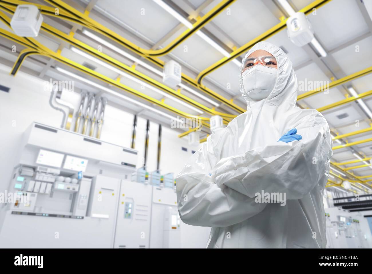 Worker or engineer wears protective suit or white coverall suit work in semiconductor manufacturing factory Stock Photo