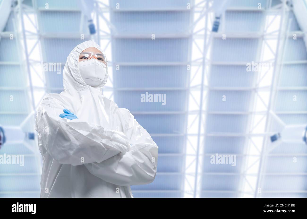 Worker or engineer wears protective suit or white coverall suit work in semiconductor manufacturing factory Stock Photo
