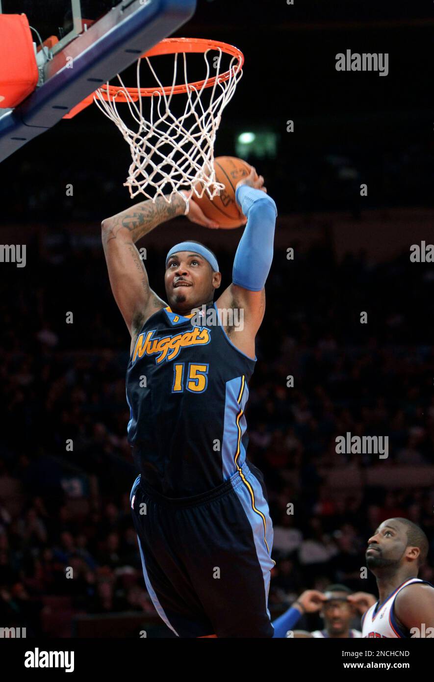 Denver Nuggets' Carmelo Anthony dunks the ball in the second half of the  NBA basketball game against the New York Knicks in New York, Sunday, Dec.  12, 2010. The Knicks beat the, image size:885x1390
