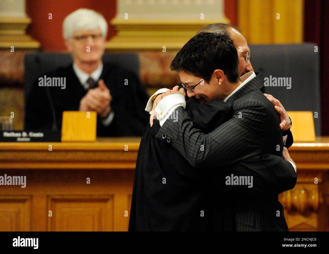 Newly sworn in State supreme court justice Monica Marquez hugs her