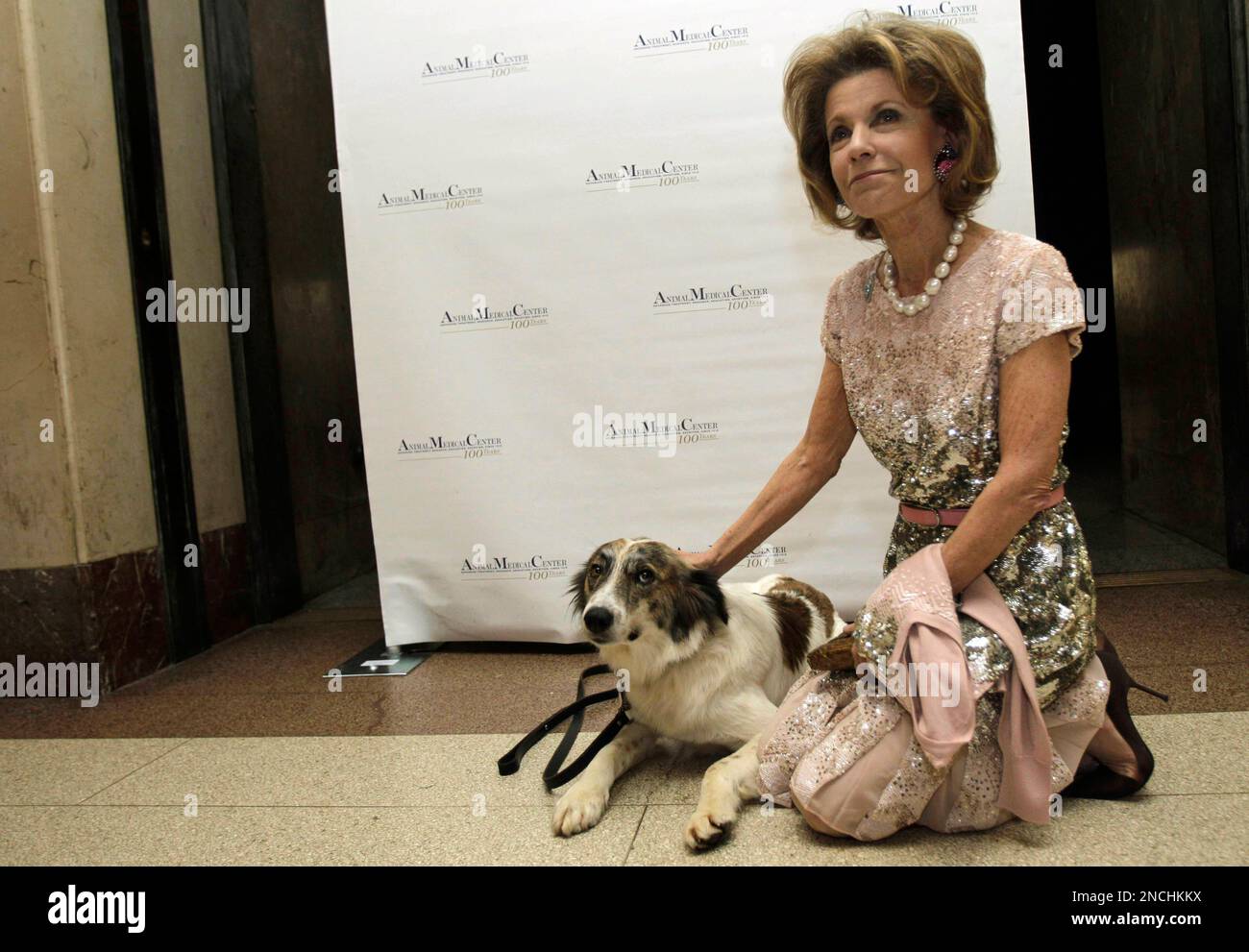 Katharine Rayner, a major donor, poses for a photograph with Rufus, a
