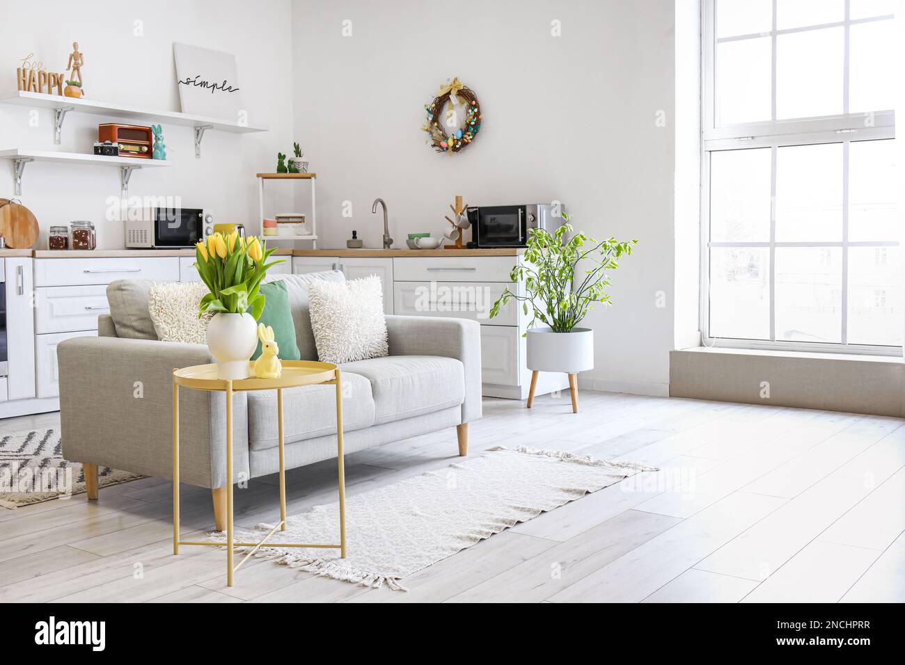 Interior of kitchen with Easter decor, white counters and sofa Stock ...