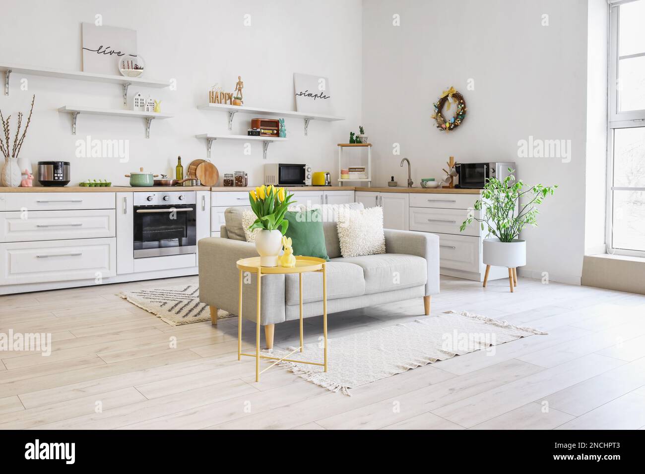 Interior of kitchen with Easter decor, white counters and sofa Stock ...