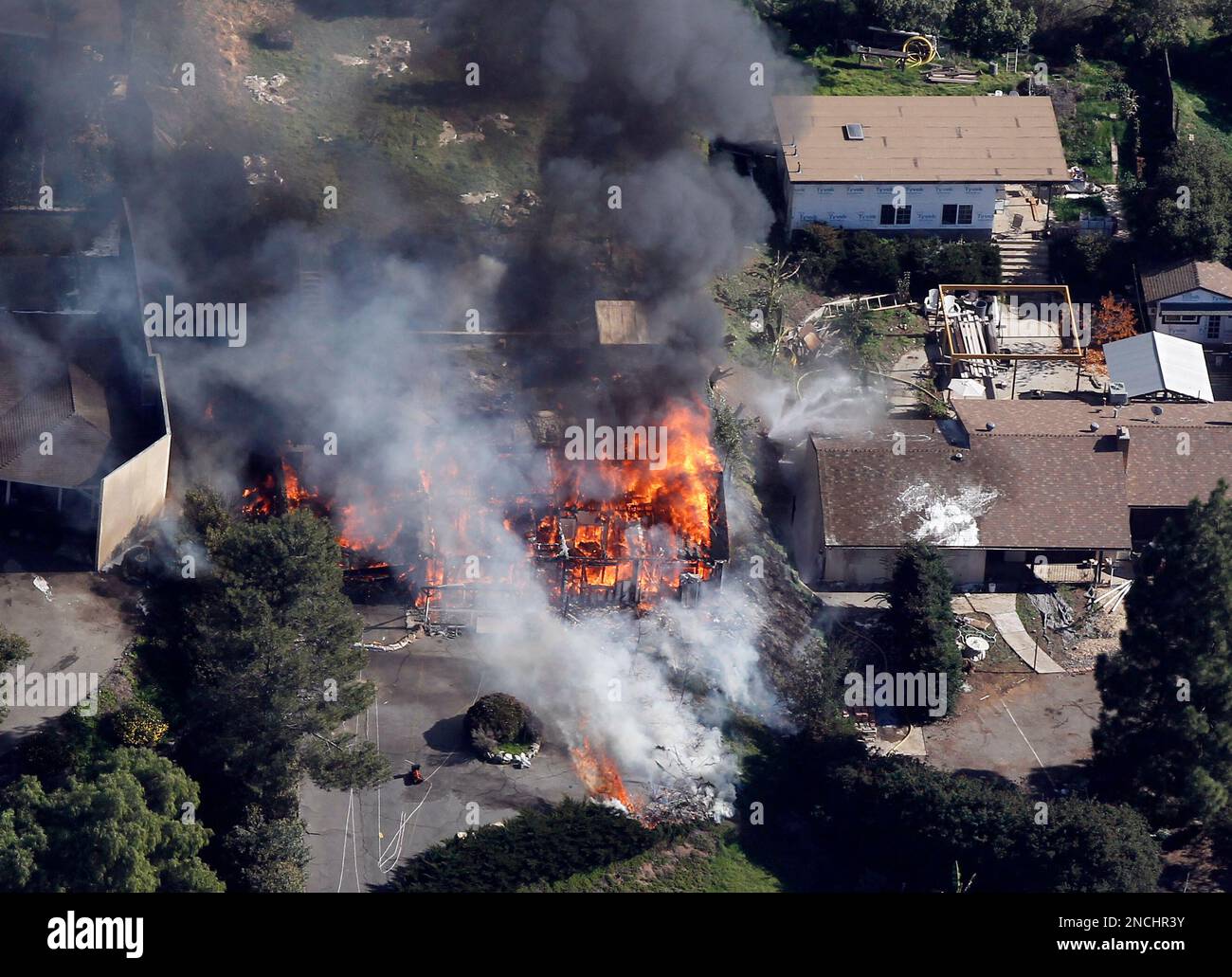 A suburban home erupts in flames on Thursday, Dec. 9, 2010 during 