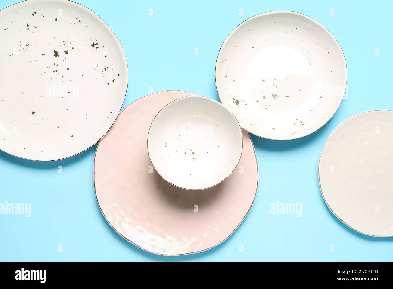 Set of empty ceramic plates on color background Stock Photo - Alamy